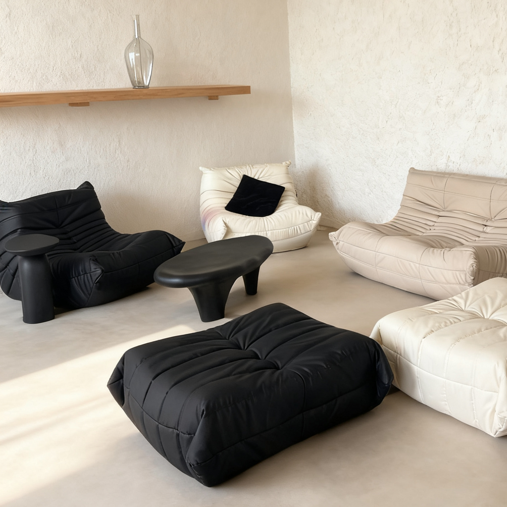 Modern living room with black and white bean bag chairs on a light floor.