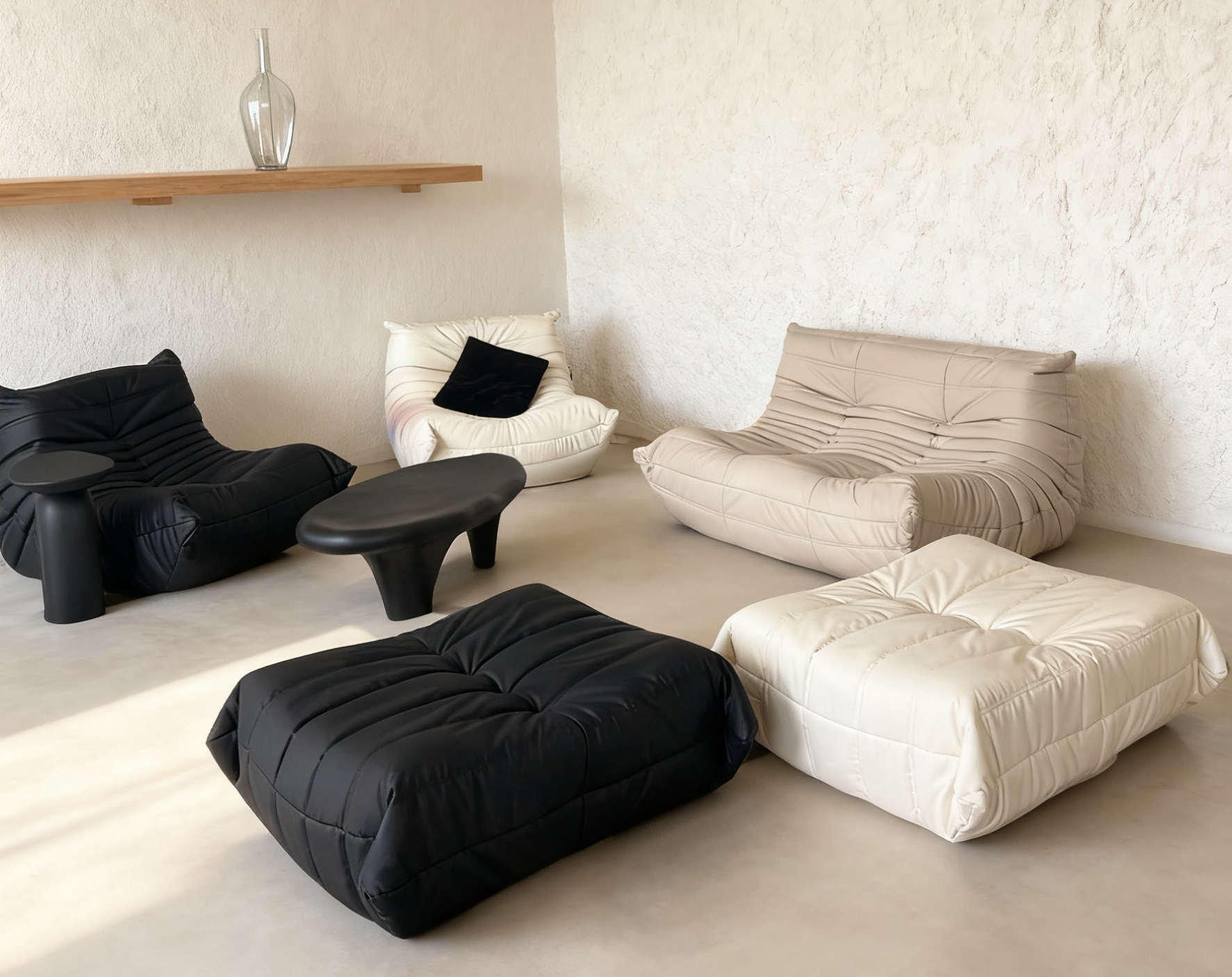 Modern living room with black and white bean bag chairs on a light floor.
