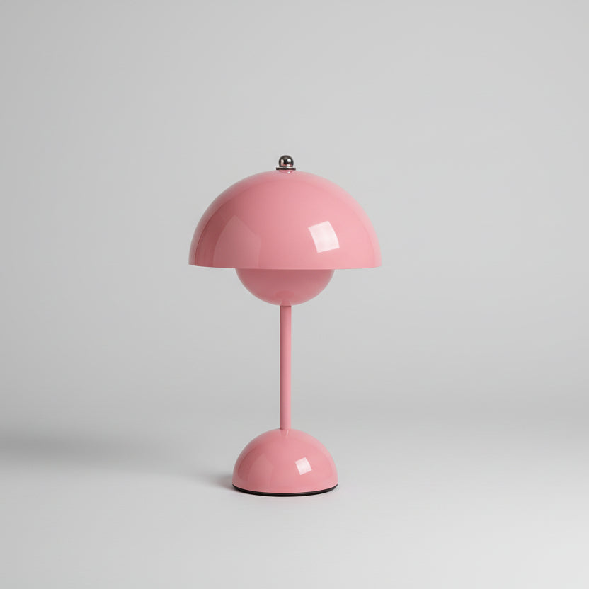 Pink lamp with a vase of flowers on a light-colored wall