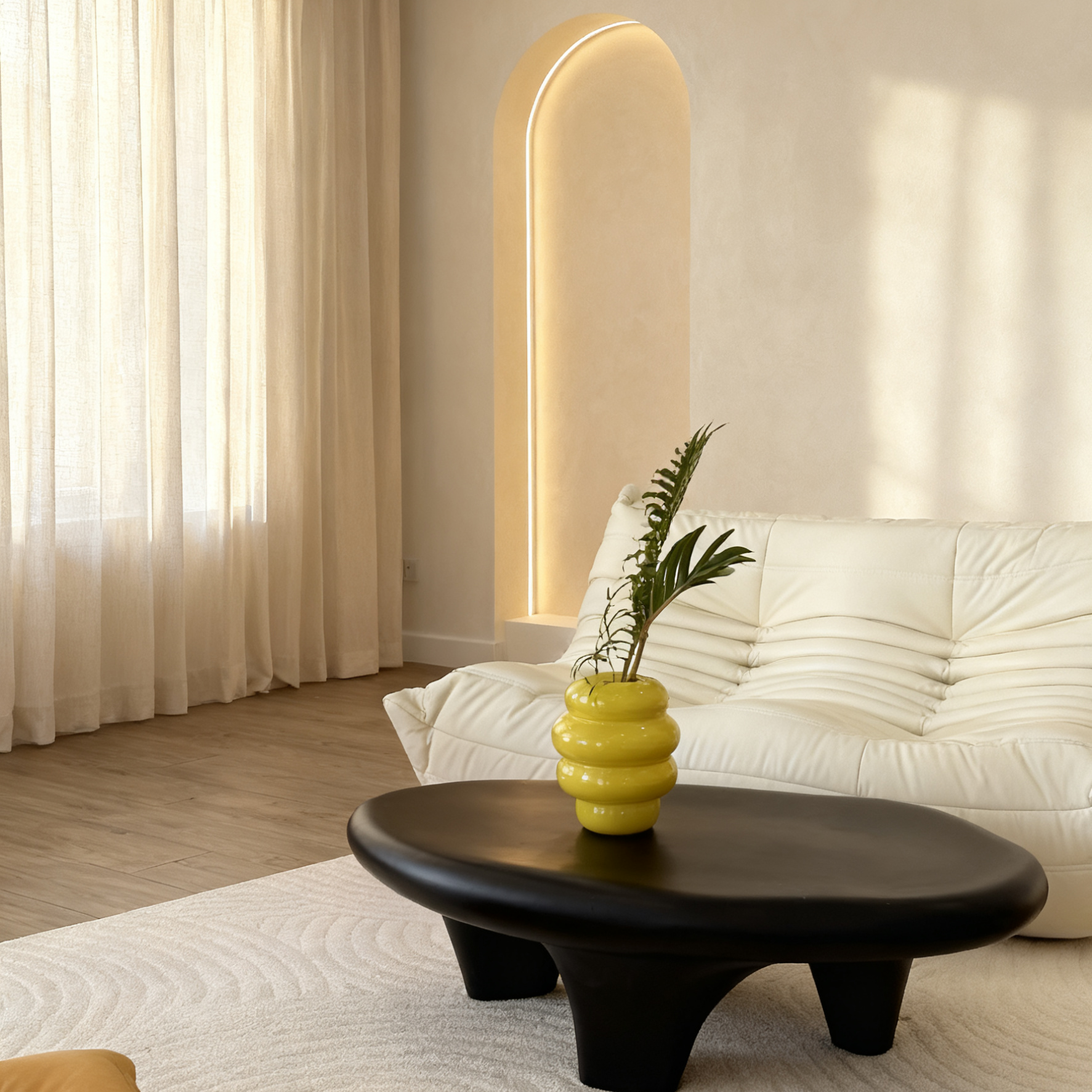 Modern living room with a white sofa, wooden coffee table, and decorative elements.