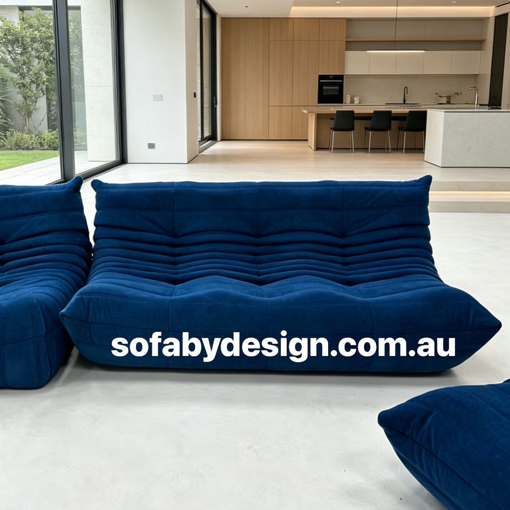 Royal blue Togo-inspired sofa styled in an open-plan home