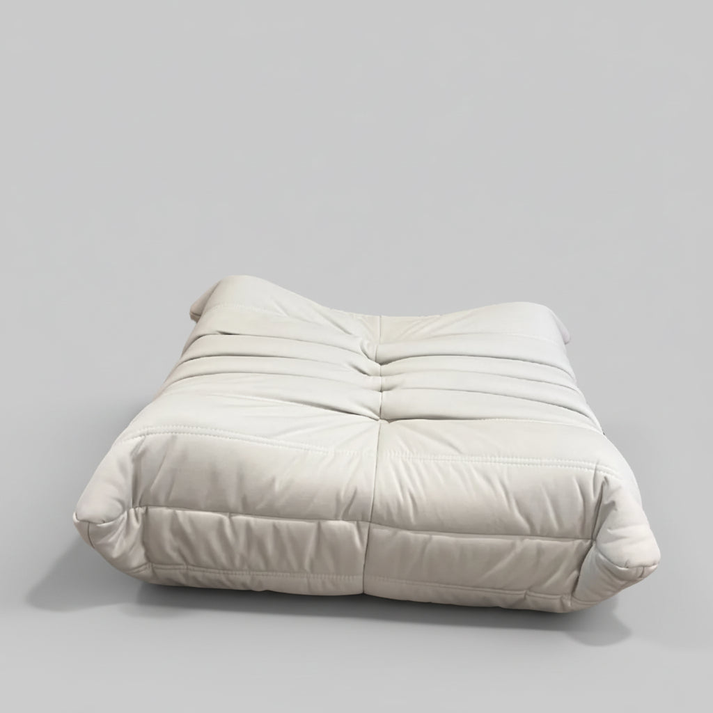 White cushion on a wooden door with abstract art in the background