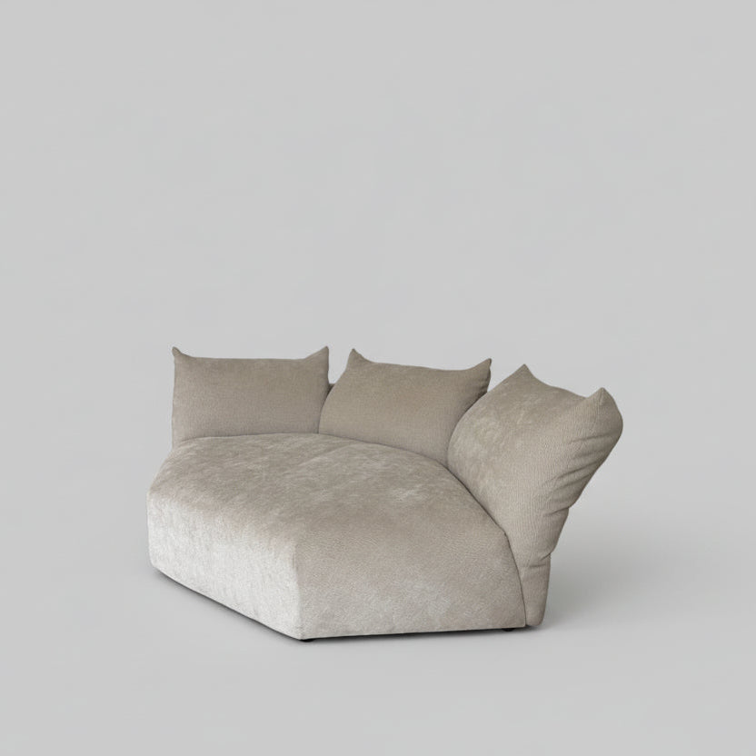 Beige pillows on a bed against a white wall
