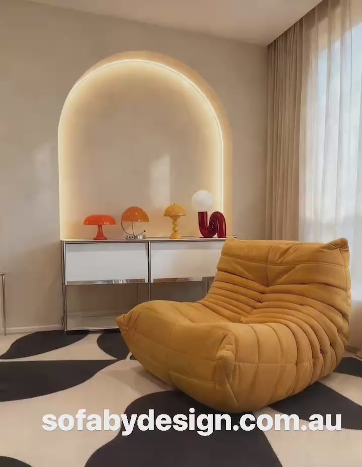 Yellow Togo-inspired lounge chair in a neutral living room