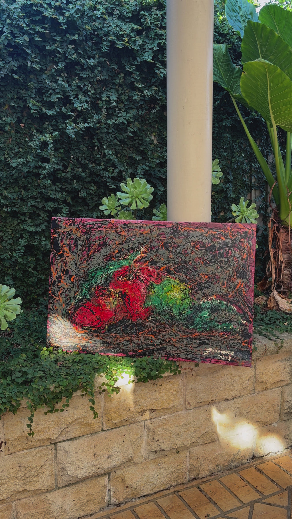 A striking still life painting of fruit, created with acrylic and enamel paint on canvas. Vibrant red, green, and golden tones emerge from a textured dark background, blending realism with expressive abstraction